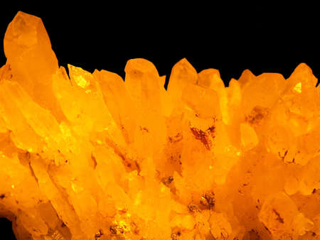 golden crystals isolated on black backgroundの写真素材
