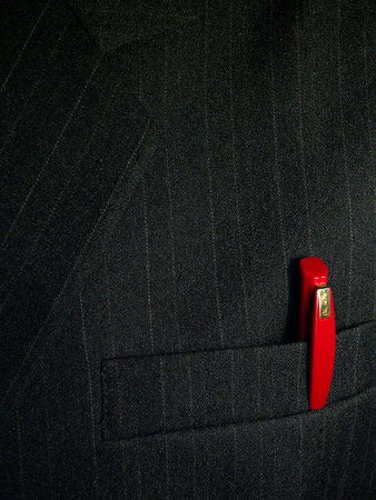 Red pen in the pocket of a businessmanの写真素材