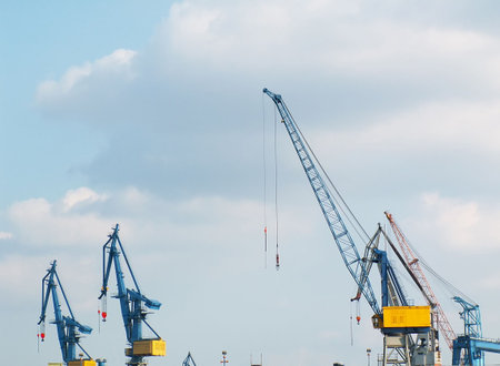 Cranes at working site on blue sky background