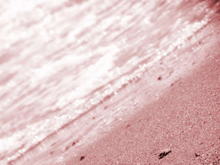 beach and waves in warm light at sunriseの写真素材