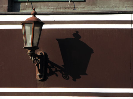 Old classic street lamp and shadow from an old house wallの写真素材