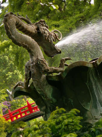 Statue of a dragon from a fountain in a japanese gardenの写真素材