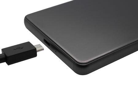 Micro Usb cable and a phone with micro Usb port on white background. cable for charging and data transfer.の写真素材
