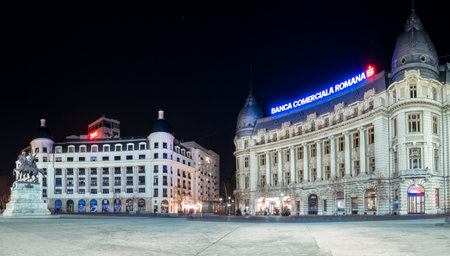Bucharest/Romania â 02.29.202:Oscar Maugsch Palace in the center of Bucharest. Night photo with the Headquarters of the Romanian Commercial Bank ( BCR).のeditorial素材