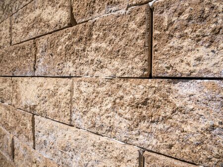 Stone wall background. Wall made of granite stone blocks.の写真素材