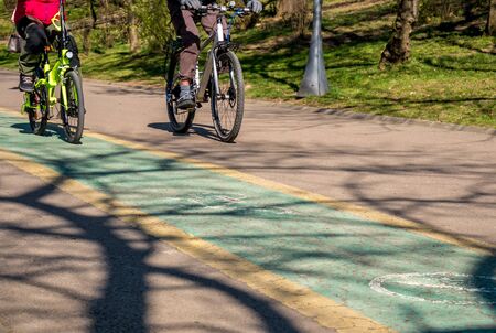 People in the park ridding bicycles. Bicycle lane in the park.の写真素材