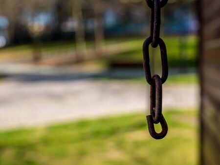 Close up with a rusted chain and blurred backgroundの写真素材