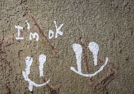 " I'm ok" written on a tree bark with white paint.の写真素材