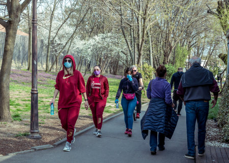 Bucharest/Romania - 03.19.2020: Women in the park wearing wearing a face mask for protection against Coronavirus pandemic. Girls walking in the park.のeditorial素材