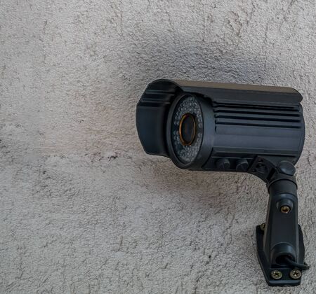 Close up with a security surveillance camera. CCTV camera on a wall.の写真素材