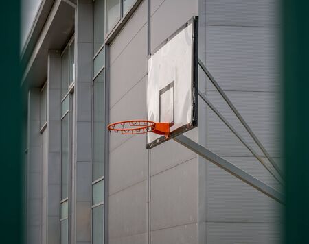 Orange outdoor basketball hoop with no net.の写真素材