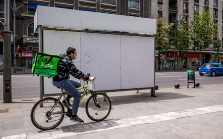 Bucharest/Romania - 05.07.2020: Uber eats courier on a bicycle delivering the order.のeditorial素材