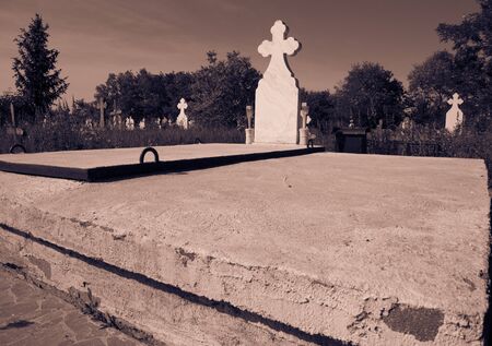 Graves, tombstones and crosses in the cemetery. A graveyard in Romania.の写真素材