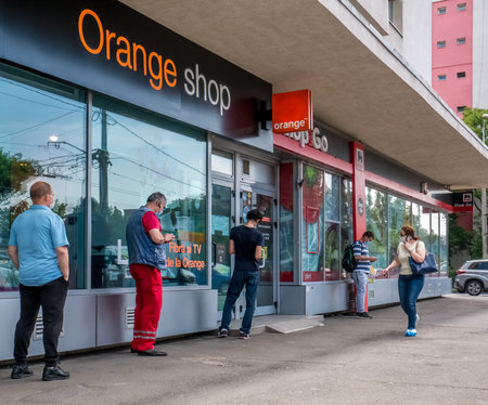 Bucharest/Romania - 05.16.2020: People waiting in line in front of a Orange Shop respecting the social distancing to prevent and stop the coronavirus outbreak.のeditorial素材