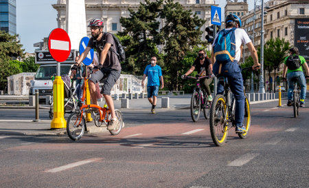 Bucharest/Romania - 05.16.2020: People riding bicycles on a bicycle lane in the center of Bucharest. People enjoying a nice day in the center of Bucharest after the coronavirus lockdown was lifted.のeditorial素材