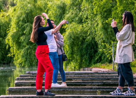 Bucharest/Romania - 05.23.2020: People taking pictures of each other in the Youth Park, Bucharest. Couple taking a selfie.のeditorial素材