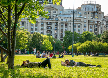 Bucharest/Romania - 05.30.2020: People lying on the grass in the center of Bucharest, enjoying a nice day after Coronavirus lockdown was lifted.のeditorial素材