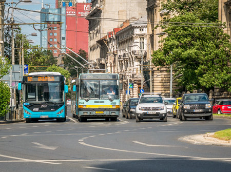 Bucharest/Romania - 05.30.2020: Buses belonging to Bucharest Transit Corporation waitting at stop light in the center of Bucharest.のeditorial素材