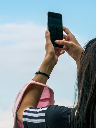 Girl taking a picture with her smartphone.のeditorial素材