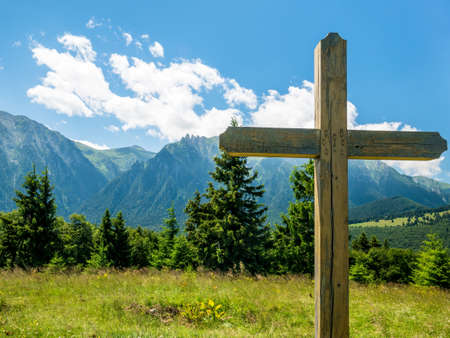 A cross with Bucegi Mountains in the background. Beutiful landscape with Carpathian Mountains in Romania.の写真素材