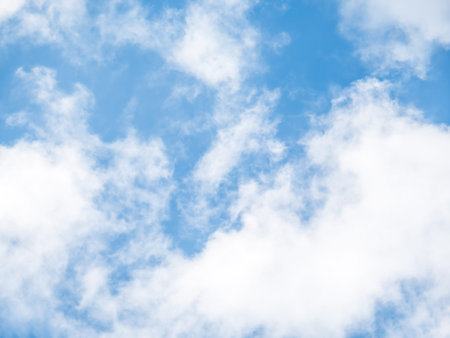 White clouds on a blue sky background.