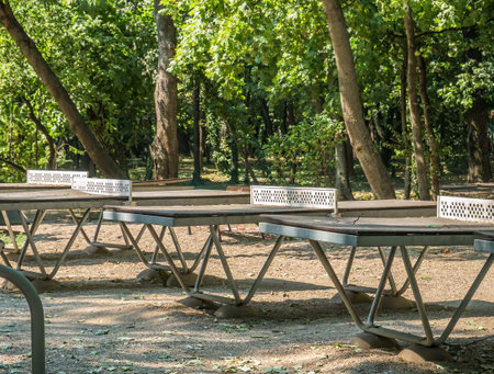 Worn out table tennis in Herestrau park, Bucharest.. Outdoor metal tables for tennis.