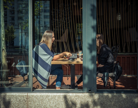 Bucharest/Romania - 09.19.2020: Two girls sitting at a table in a cafe in the center of Bucharest.のeditorial素材