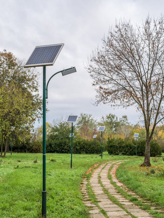 Alley in the park with lighting poles and photovoltaic panel LED lamp lights .の写真素材
