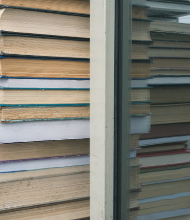 Row of old books reflecting in a mirror or window..の写真素材