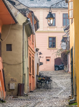 Sighisoara Romania - 11.26.2020: Scene with cobblestone streets and old buildings of Sighisoara Medieval Fortress, in Romania.のeditorial素材