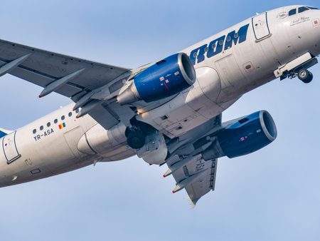 Otopeni, Romania - 01.23.2021 - Detail close up with a Tarom Airbus A318-111 (YR-ASA) airplane flying against blue sky.のeditorial素材