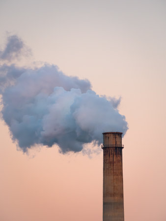 Dense smoke and steam coming out from the industrial chimney. Environmental Pollution concept.の写真素材