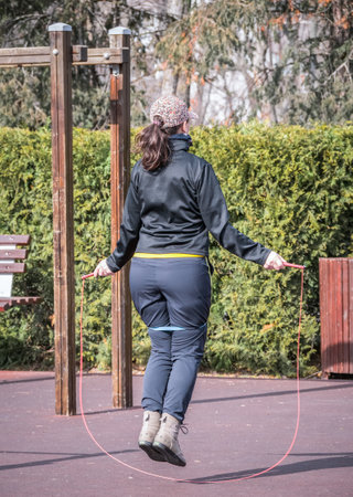 Girl in the park training with jump ropeの写真素材