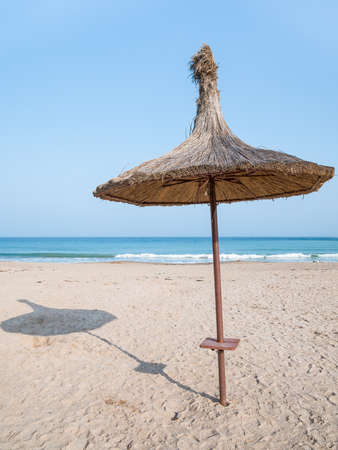 Summer landscape with straw umbrellas on the beach in Mangalia or Mamaia. Beach at the Black Sea in Romania.の写真素材