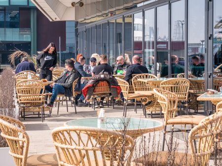 Constanta, Romania - 02.25.2021: People enjoying a nice day at a outdoor terrasse or cafe restaurant in Tomis Turistic Port, Constantaのeditorial素材