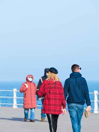 Constanta, Romania - 02.25.2021: Couples out for a relaxing walk or stroll on Constanta seafront (Faleza Cazino Constanta).のeditorial素材