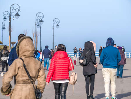 Crowd of people out for a walk on a nice day on Constanta seafront, Romania. Many people strollingの写真素材