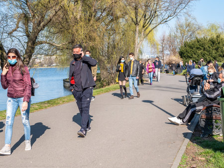 Bucharest, Romania - 03.26.2021: Many people out for a walk or stroll in King Mihai I Park (herestrau). Busy day in the parkのeditorial素材