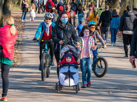 Bucharest, Romania - 03.26.2021: Many people out for a walk or stroll in King Mihai I Park (herestrau). Busy day in the parkのeditorial素材