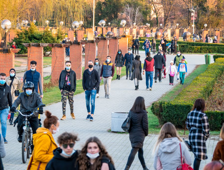 Bucharest, Romania - 03.26.2021: Many people out for a walk or stroll in King Mihai I Park (herestrau). Busy day in the parkのeditorial素材