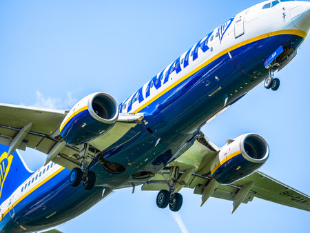 Otopeni, Romania - 05.08.2021: Ryanair Boeing 737-8AS (9H-QAM) flying against blue sky. Airplane arriving at Henry Coanda International Airport.のeditorial素材