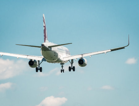 Otopeni, Romania - 05.08.2021: Qatar Airways Airbus A320-232 (A7-AHT) flying against blue sky. Airplane arriving at Henry Coanda International Airport.のeditorial素材