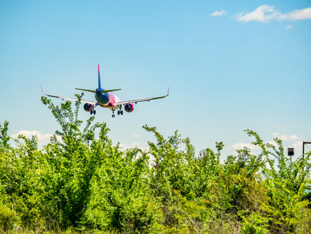 Otopeni, Romania - 05.08.2021: A Wizz Air Airbus A321-271NX (HA-LVi) airplane flying against clear blue sky.のeditorial素材