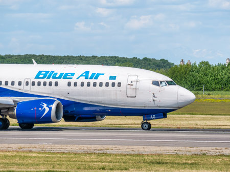 Otopeni, Romania - 05.14.2021: A Blue Air Boeing 737-5L9 (YR-BAG) airplane on the airport runway at Henri Coanda International Airport.のeditorial素材