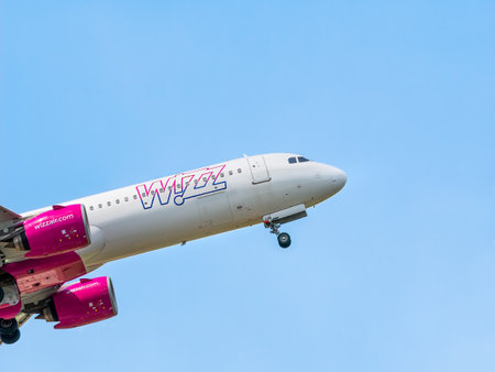 Otopeni, Romania - 05.11.2021: A Wizz Air Airbus A321-271 NX (HA-LVD) airplane flying against blue cloudy sky from Henri Coanda International Airport.のeditorial素材