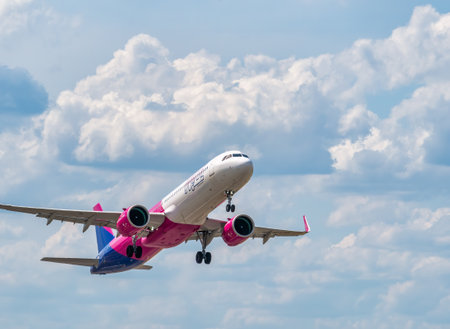 Otopeni, Romania - 05.11.2021: A Wizz Air Airbus A321-271 NX (HA-LVD) airplane flying against blue cloudy sky from Henri Coanda International Airport.のeditorial素材
