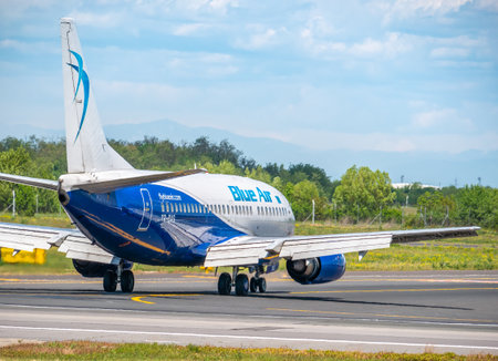 Otopeni, Romania - 05.14.2021: A Blue Air Boeing 737-5L9 (YR-BAG) airplane on the airport runway at Henri Coanda International Airport.のeditorial素材