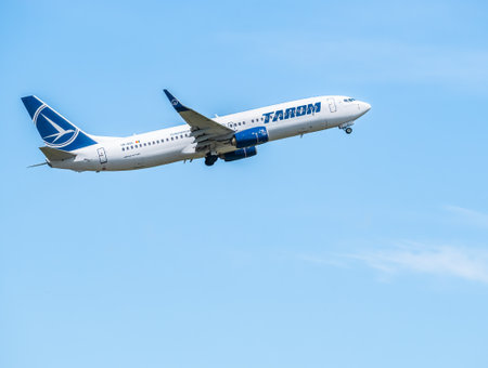 Bucharest, Romania - 05.14.2021: YR-BGL TAROM BOEING 737-800 airplane flying against clear blue skyのeditorial素材