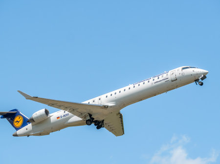 Bucharest, Romania - 05.14.2021: Lufthansa CityLine D-ACKI Mitsubishi CRJ-900LR airplane flying against clear blue sky. Airplane takes off from Henri Coanda International Airport.のeditorial素材