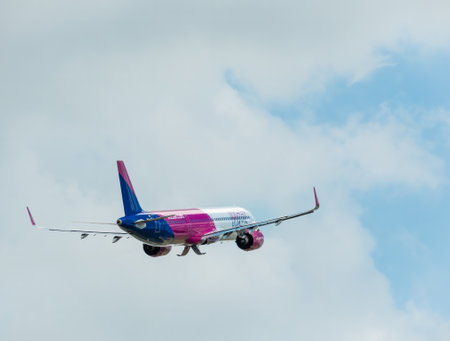 Otopeni, Romania - 05.11.2021: A Wizz Air Airbus A321-271 NX (HA-LVD) airplane flying against blue cloudy sky from Henri Coanda International Airport.のeditorial素材